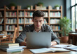 © Pier Fax - Focused Student Studying in a Quiet Library with a laptop