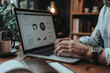 © Michael - Businessman working on laptop showing statistics at home office