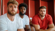 © Lens Legacy - Three young men sit together in a locker room, dressed in casual sports attire, exuding a mix of relaxed ease and readiness for their upcoming athletic challenge.