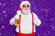 © deagreez - Close-up portrait of his he nice cheery glad cheerful satosfied bearded thick fat Santa drinking beer showing thumbup isolated over bright vivid shine vibrant violet lilac background
