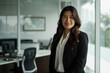 © darshika - Confident Latin mid aged female executive in office portrait.