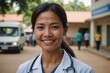 © ThomasLENNE - Close portrait of a smiling 40s Cambodian woman doctor looking at the camera, Cambodian hospital blurred background