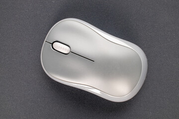 One computer mouse wirelessly connected to a computer mat, macro, top view.