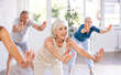 © JackF - Group of mature active people dancing modern dance movements in studio