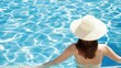 © ChimE - A joyful young woman enjoys serenity in a pool, embodying the essence of a perfect beach holiday.