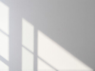 Wall Mural - Shadows from window blinds create a pattern on a light-colored wall during a sunny afternoon