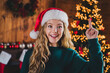 © deagreez - Photo of nice teen girl point finger up eureka wear green christmas clothes enjoy modern cozy x-mas party decoration interior flat indoors