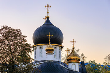 Wall Mural - A church with a gold cross on top of it