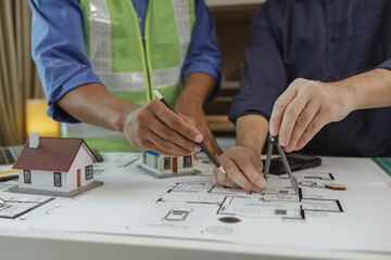 Poster - an architect and an engineer are discussing about big projects that they have to take responsibility for together, engineer and his assistant are meeting about the first draft of blueprint