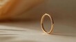 © Rainister - Simple and minimalist jewelry, such as a thin gold ring or necklace, placed against a neutral background to highlight its elegance