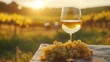 © wacharagorn - A tranquil scene featuring a glass of white wine beside fresh grapes, bathed in warm sunset glow over a vineyard.