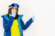 © Evaldas - Skier young woman wearing warm padded windbreaker jacket hat ski goggles mask point index finger aside on copy space blank area travel rest spend weekend winter season. Isolated on white background