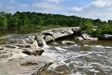 Wall Mural - Landscape waterfall in McKinney Roughs Nature Park with forest trees in Texas on a sunny day