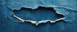 © Aziz - A close-up shot of ripped blue denim fabric with a hole revealing a blank space.