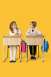 © Pixel-Shot - Cute children with molecular models sitting at school desks on yellow background