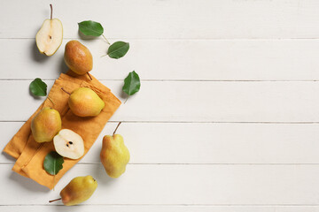 Wall Mural - Sweet ripe pears and leaves on white wooden background