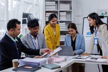 Wall Mural - Group of confident business asian people point to graphs and charts to analyze market data, balance sheet, account, net profit to plan new sales strategies to increase production capacity.	