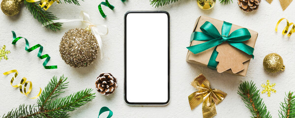 Digital phone mock up with rustic Christmas decorations for app presentation top view with empty space for you design. Christmas online shopping concept. Tablet with copy space on colored background