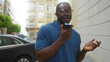 © Krakenimages.com - Young man talking on phone outside in urban city street