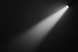 © Tanakrit - A beam of light cuts through darkness, showcasing the contrast of illumination against a black background.