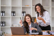 © wichayada - Professional Businesswomen Collaborating and Consulting with Colleagues in a Modern Office Environment