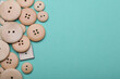 © splitov27 - Wooden buttons on mint green background. Copy space