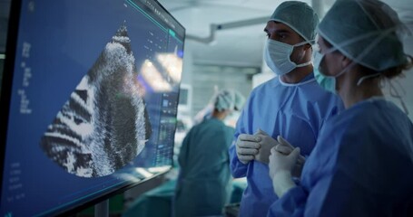 Aufkleber - Caucasian Male and Female Surgeons Analyze Ultrasound Image on a Digital Monitor, Planning Surgical Strategy in a High-tech Operating Room. Colleagues Working Together, Preparing for Surgery