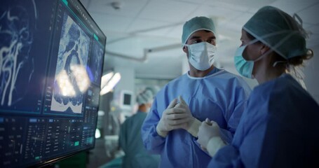 Aufkleber - Caucasian Male and Female Surgeons Analyze Patient's Scans on a Digital Monitor, Planning Surgical Strategy in a High-tech Operating Room. Colleagues Working Together, Preparing for Surgery