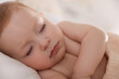 © New Africa - Cute little baby sleeping on bed at home