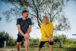 © standret - Lunges exercise. Senior couple together outdoors at nature