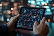 © Odin AI - Hands holding a tablet displaying detailed stock market analytics with advanced visual graphics, emphasizing technology and financial insights in a digital age.