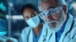 © pisan thailand - Senior male medical doctor wearing glasses and protective face mask examining patient with female nurse assistant in hospital clinic or medical facility setting