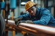 © Сергей Косилко - An African-American mechanical engineer chooses a copper tube and looks at the camera