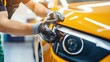 © almeera - Car Detailing: Applying Protective Coating to a Yellow Car