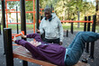 © Marko Geber - Senior male friends working out at outdoor exercise park