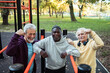 © Marko Geber - Senior men flexing muscles after outdoor workout at park fitness station