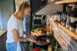 © Geber86 - Young woman cooking healthy vegetables in modern kitchen