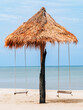 © JinnaritT - Wooden swing on beach. Relaxing, peaceful vacation scene at beach. Old wooden Swing with beautiful sea and sky blue, Relaxing by sea. holiday and vacation destination to tropical. Wooden rope swings.