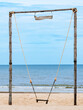 © JinnaritT - Wooden swing on beach. Relaxing, peaceful vacation scene at beach. Old wooden Swing with beautiful sea and sky blue, Relaxing by sea. holiday and vacation destination to tropical. Wooden rope swings.