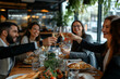 © Татьяна Евдокимова - Group of cheerful business people toasting with white wine while having a business lunch together in a restaurant