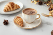 © Concept Island - Breakfast with a cup of hot chocolate with cocoa chips and croissants, with luxury crockery in an elegant setting.