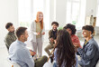 © Studio Romantic - Business people team participates in a group meeting, sitting in a circle in the office. Team engages in conversation and collaboration, working together in a professional and teamwork environment.