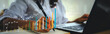 © Urupong - 2025 Businesswoman analyzing company financial balance sheet working with digital virtual graphics Businessman calculating financial data for long term investment growth goals