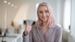 © Tom - A cheerful young Caucasian woman in a stylish gray suit gives a thumbs up, exuding confidence and positivity in a modern office setting.