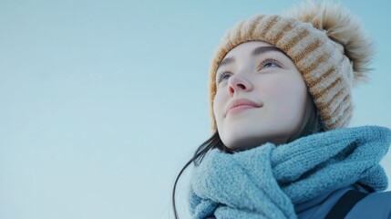 Mid-shot of an Eastern European woman in casual winter attire, plain background in light blue tones.