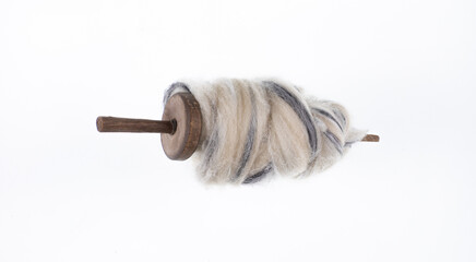 spindle with wool isolated on white background