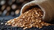 © cac_tus - Burlap sack spilling wood chips on black surface, rustic background. Sustainable materials and eco-friendly concept