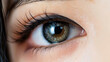 © Jirut - An extreme close-up shot of a beautiful young Asian woman's eye, with her vibrant and colorful contact lens.
