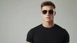 © Steven - Stylish Young Man: Young man in a black t-shirt and sunglasses posing against a clean background.