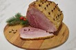 © Natalia - Christmas baked ham on a wooden board.